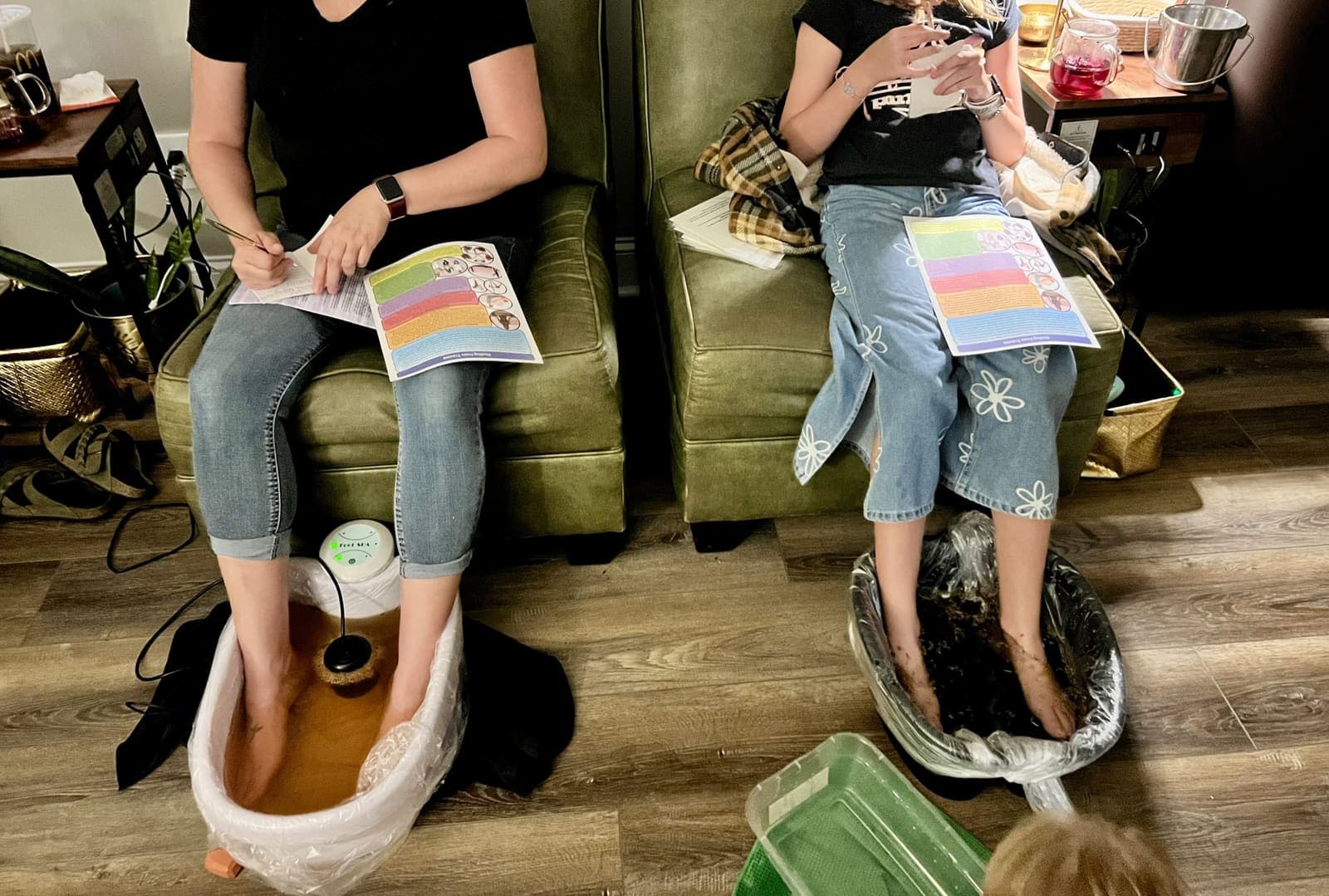 Two guests enjoying an herbal foot bath at Olive Tree